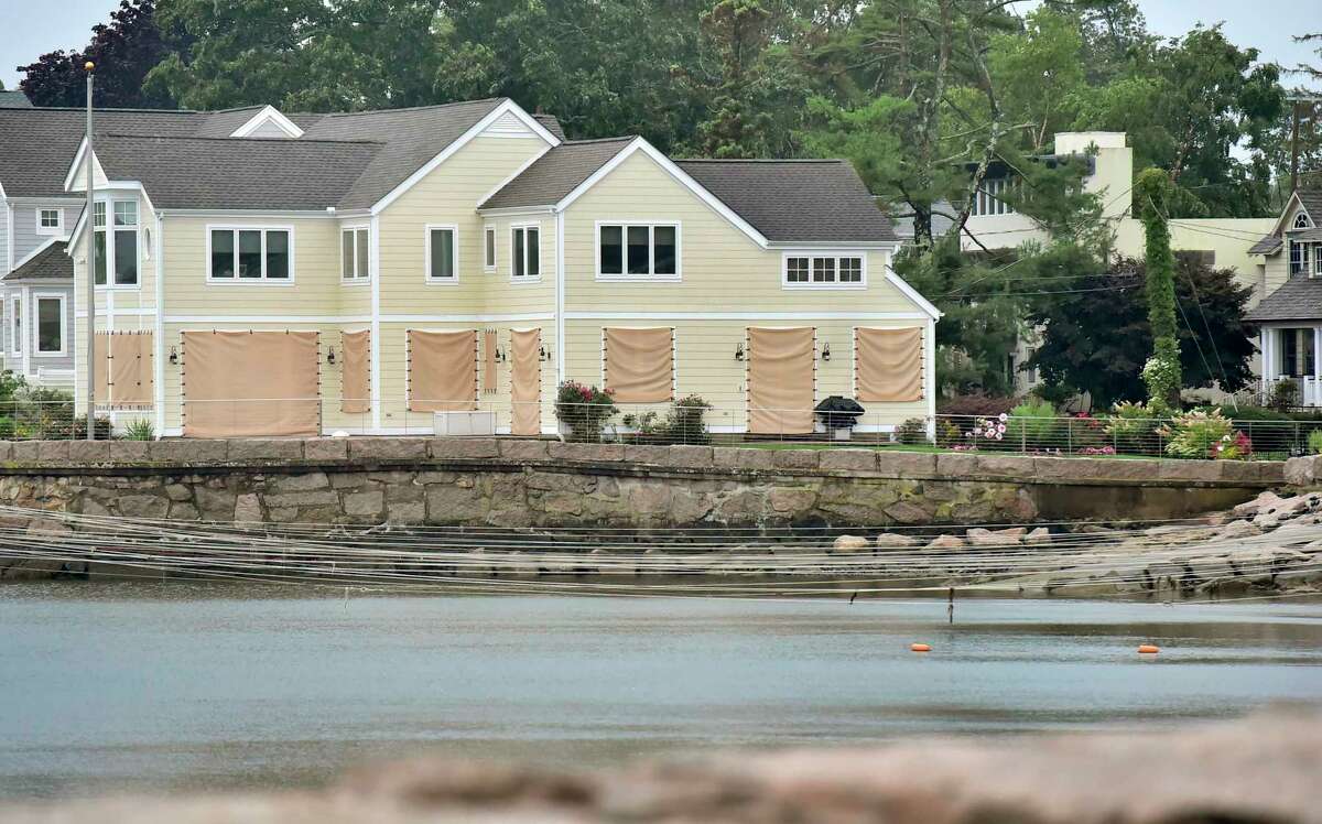 A boarded up house prepped for Hurricane Henri early Sunday morning facing Long Island Sound on Fourth Avenue next to the Hotchkiss Grove Association Beach in Branford.