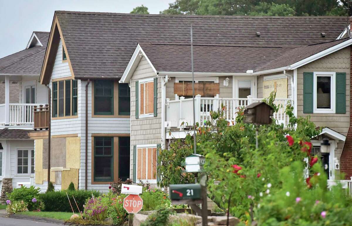 Boarded up houses prepped for Tropical Storm Henri early Sunday morning in Branford facing Long Island Sound near Second Avenue next to the Hotchkiss Grove Association Beach.