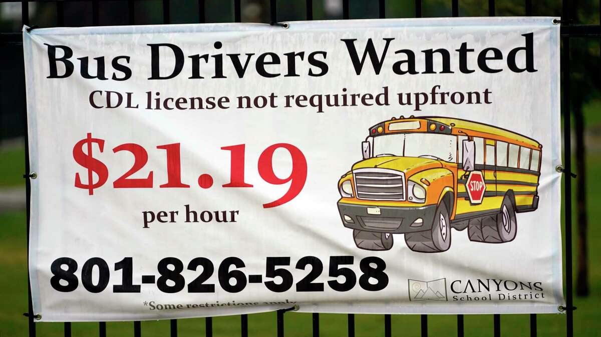 A "Bus Drivers Wanted" sign is shown Wednesday, Aug. 18, 2021, in Sandy, Utah. A shortage of bus drivers is complicating the start of a new school year already facing a surge in COVID-19 cases and conflicts over whether masks should be required in school buildings.