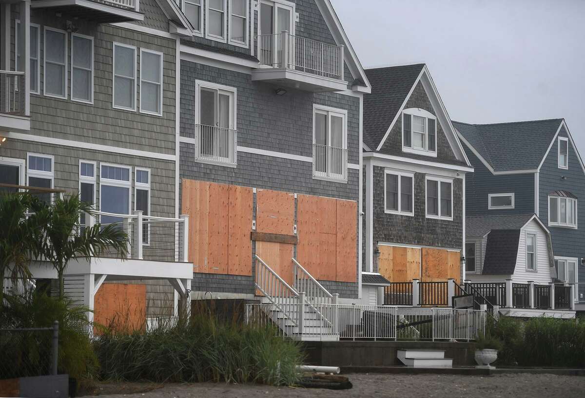 Beachfront homes are boarded up in preparation for the arrival of Tropical Storm Henri on East Broadway in Milford, Conn. on Sunday, August 22, 2021.