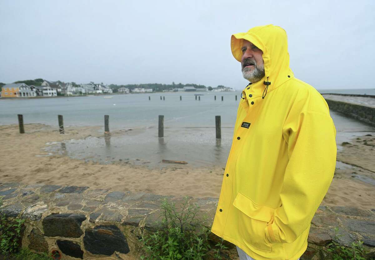 Robert Rothschild, of Madison, visits West Wharf Beach at high tide during Tropical Storm Henri in Madison on Sunday.