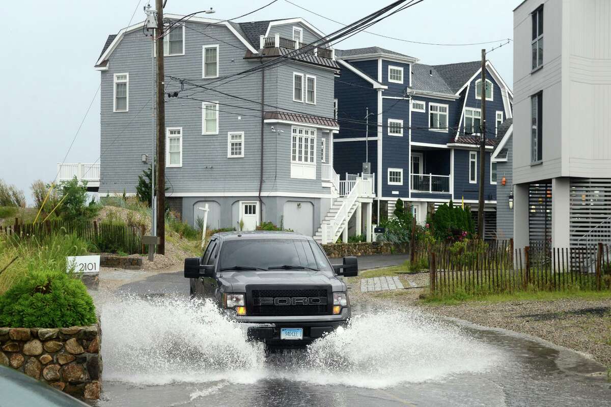 High tide brought the waters of Long Island Sound onto a short stretch of Fairfield Beach Rd., in Fairfield, Conn. Aug. 22, 2021. As Tropical Storm Henri passed farther to the east, most of coastal Fairfield County experienced an ordinary rainy day on Sunday.