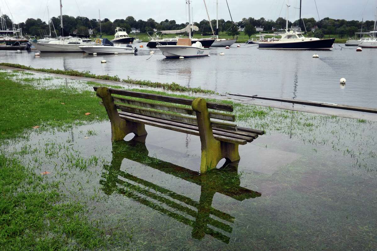 High tide brought the waters of Southport Harbor onto Perry's Green, in Fairfield, Conn. Aug 22, 2021. As Tropical Storm Henri passed farther to the east, most of coastal Fairfield County experienced an ordinary rainy day on Sunday.