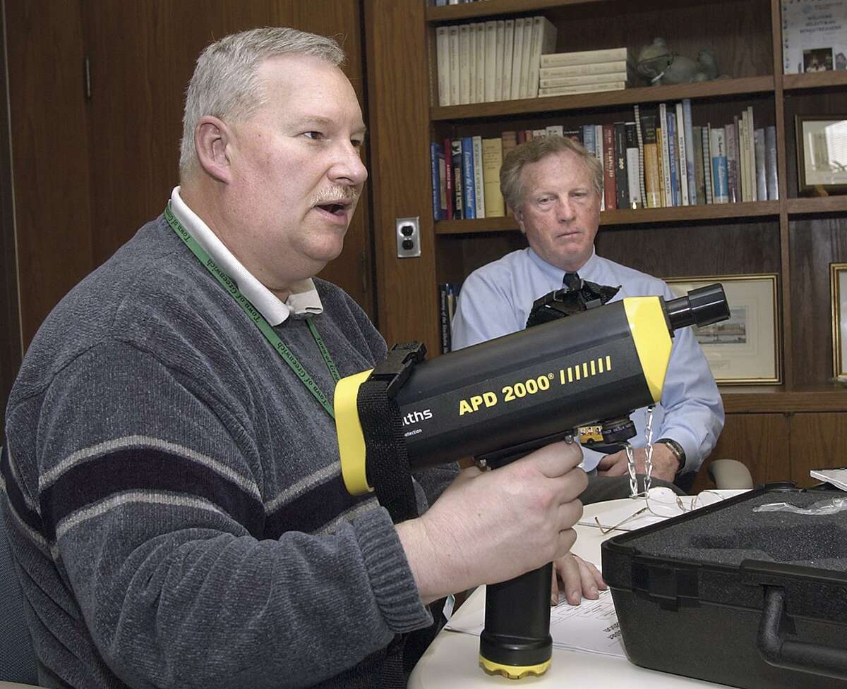 Greenwich Fire Chief , Daniel Warzoha , left, displays a APD 2000 chemical sensor unit during a press conference in 2003.