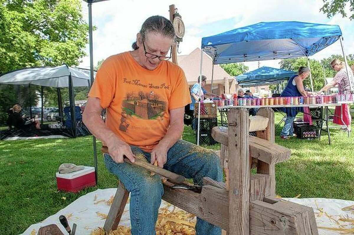 Gordon Holmes carves a bow from Osage orange wood during the Bluffs sesquicentennial celebration in Autust 2021. Holmes, a Winchester resident, has been making bows as a hobby for 35 years.