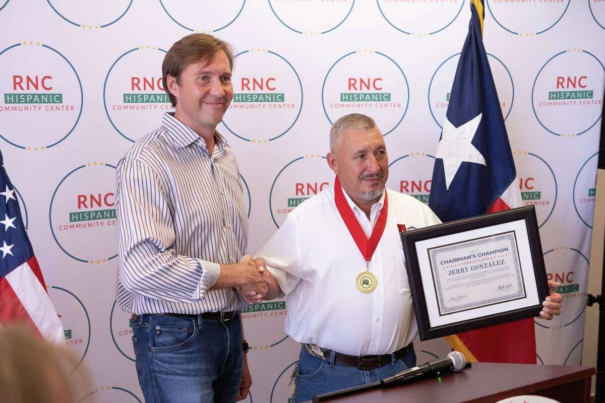 RNC Co-Chairman Tommy Hicks introduces award for Chairman's Champion to Jerry Gonzalez inside the new RNC Hispanicy Engagement Office on Aug. 21.
