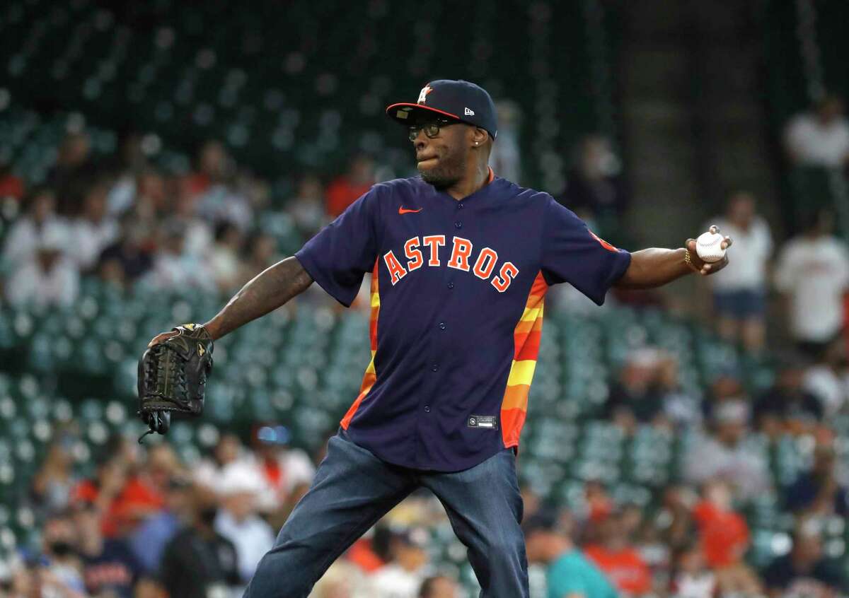 Rapper Scarface throws out the first pitch before the start of the first inning of an MLB baseball game at Minute Maid Park, Sunday, August 22, 2021, in Houston.