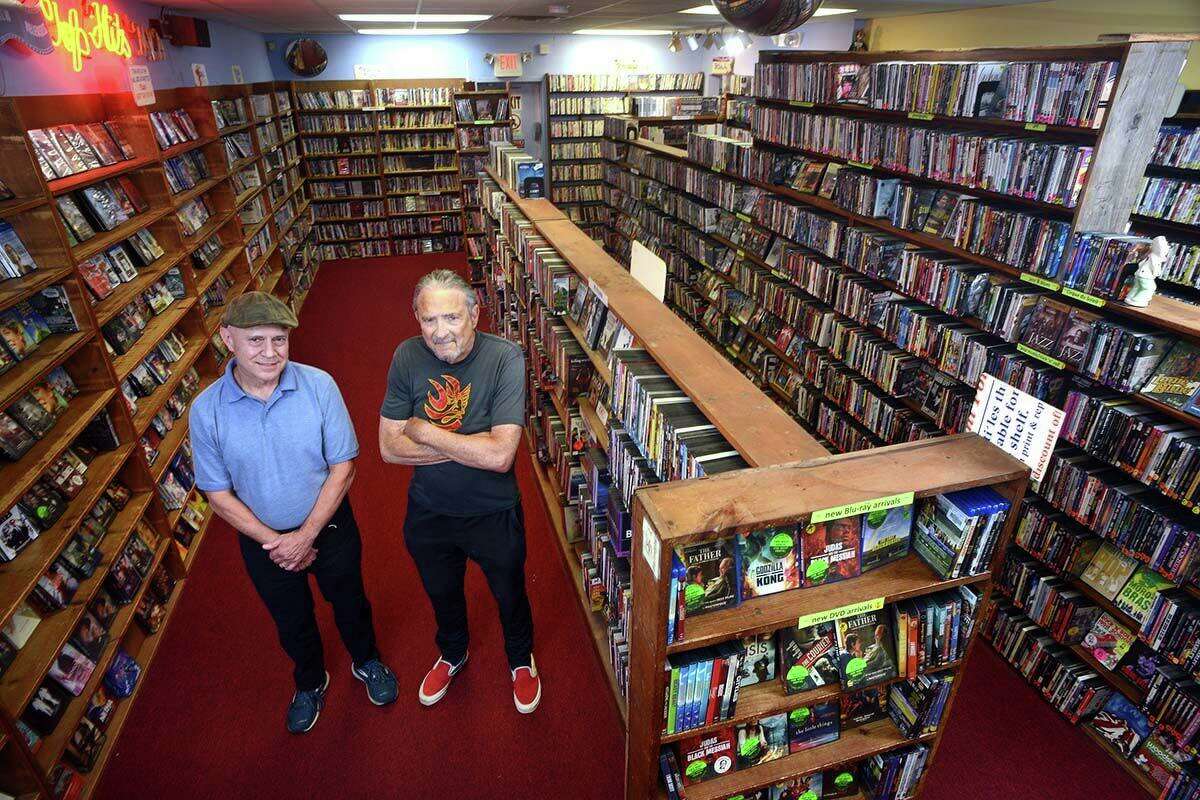 Hank Hoffman, left, and Hank Paper pose at Best Video Film & Video Cultural Center, in Hamden, Conn. July 29, 2021. Hoffman is the current director of Best Video. Paper founded Best Video in 1985.