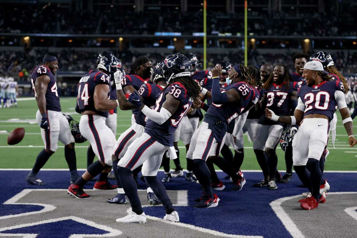 The Houston Texans defense celebrates after an interception against the Dallas Cowboys in the second half of a preseason NFL game at AT&T Stadium on August 21, 2021 in Arlington.