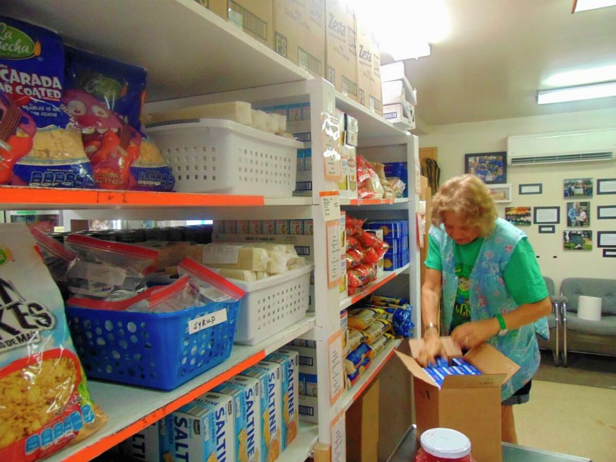 Volunteer, Marianne Cooke, who does the shopping for the pantry, helps stock shelves (Star photo/Shanna Avery)