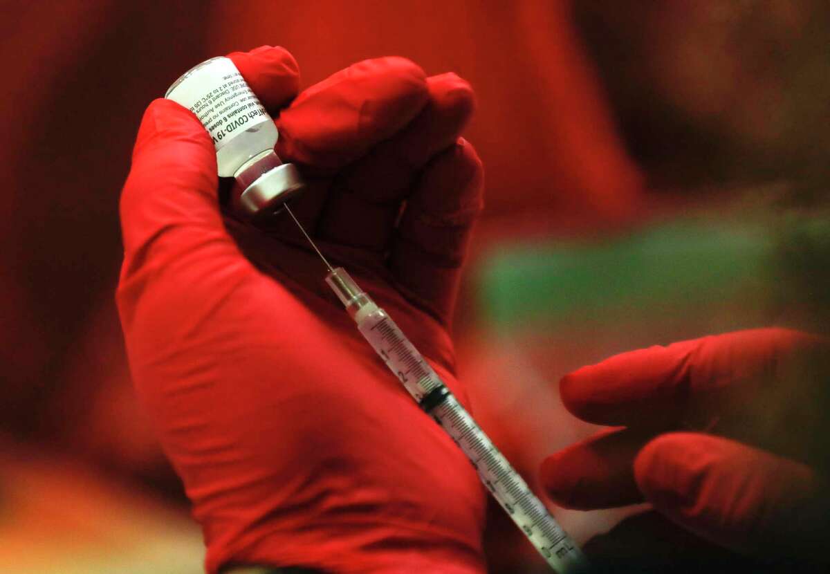 A Pfizer vaccine is drawn at one of Montgomery County's COVID-19 vaccination sites in August.