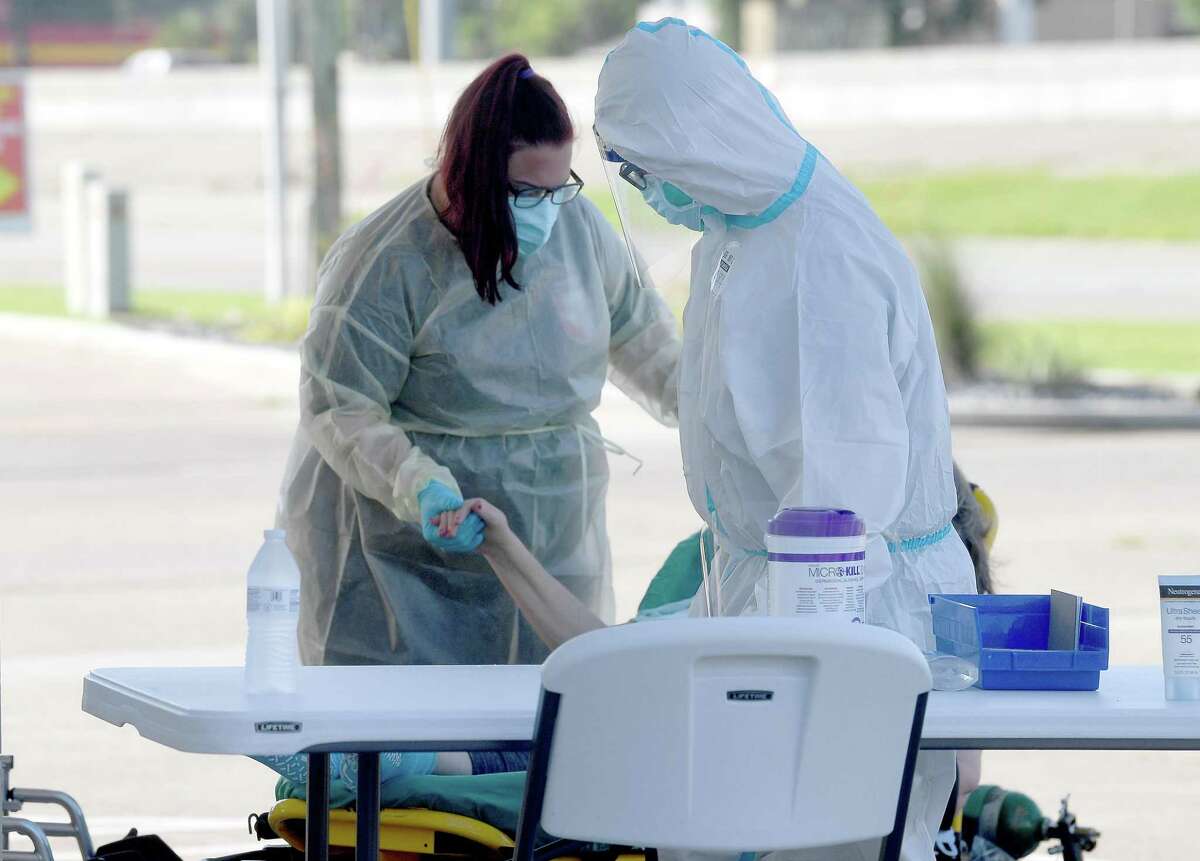 A patient is transported by ambulance workers to the new monoclonal antibody infusion center that opened Monday to help treat patients with COVID-19. The new center will be able to treat up to 150 patients daily, significantly increasing the number that can be treated amid a steep rise in cases. The treatment is free to patients 12 and older who are within 10 days of conntracting the virus and are not experiencing severe respiratory problems, Photo made Monday, August 23, 2021 Kim Brent/The Enterprise