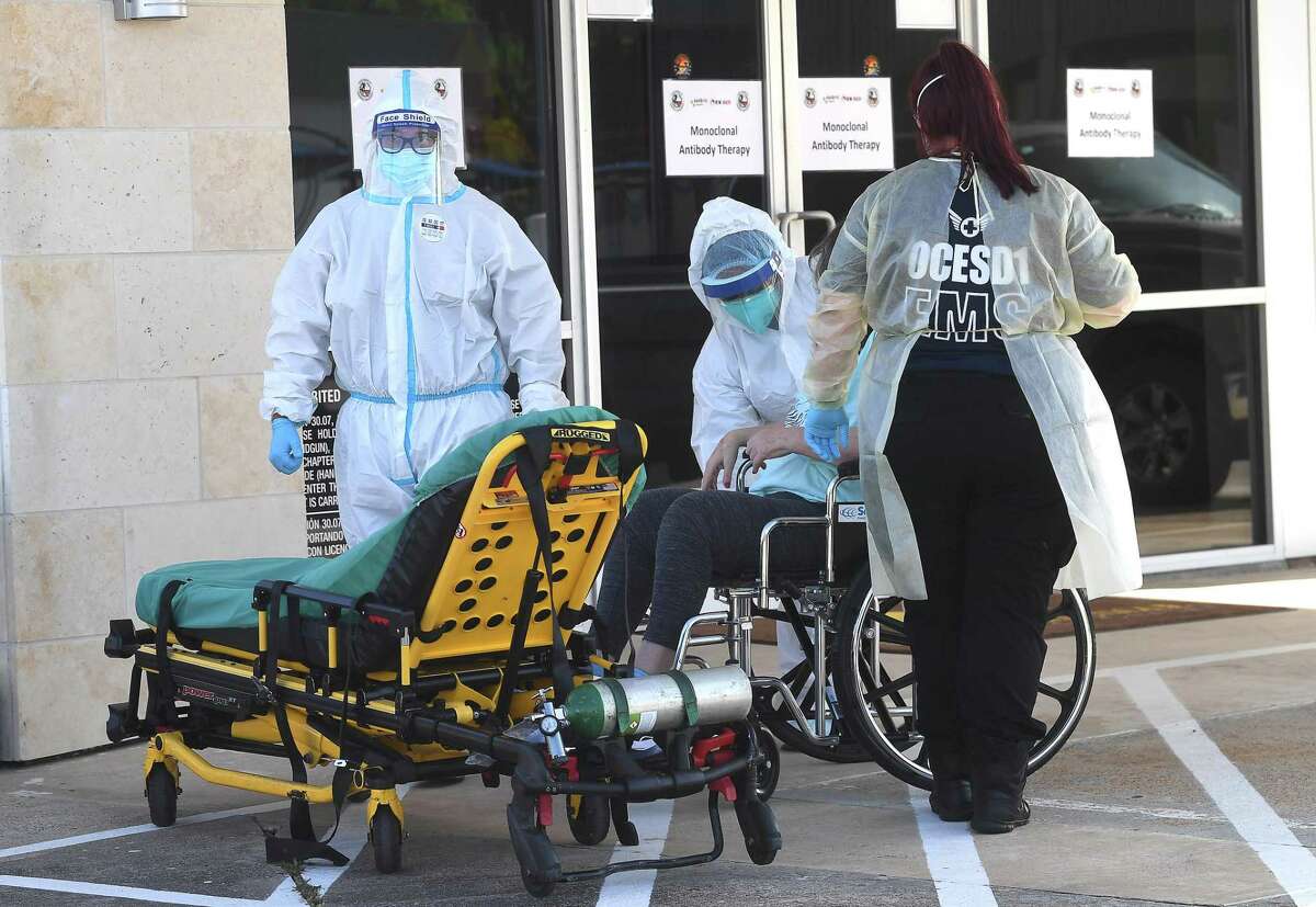 A patient is transported by ambulance workers to the new monoclonal antibody infusion center that opened Monday to help treat patients with COVID-19. The new center will be able to treat up to 150 patients daily, significantly increasing the number that can be treated amid a steep rise in cases. The treatment is free to patients 12 and older who are within 10 days of conntracting the virus and are not experiencing severe respiratory problems, Photo made Monday, August 23, 2021 Kim Brent/The Enterprise