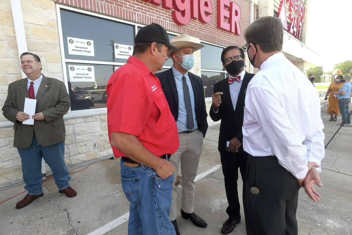 Jefferson County Judge Jeff Branick (right) and Emergency Management head Michael White (left) get an overview of what the new monoclonal antibody infusion center looks like from IEM's Gerardo Castillo (center left) and Dr. Rashid Chotani. The center opened Monday to help treat patients with COVID-19. The new center will be able to treat up to 150 patients daily, significantly increasing the number that can be treated amid a steep rise in cases. The treatment is free to patients 12 and older who are within 10 days of conntracting the virus and are not experiencing severe respiratory problems, Photo made Monday, August 23, 2021 Kim Brent/The Enterprise