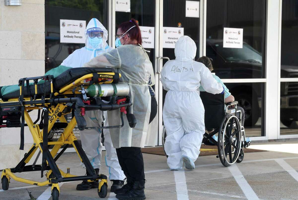A patient is transported by ambulance workers to the new monoclonal antibody infusion center that opened Monday to help treat patients with COVID-19. The new center will be able to treat up to 150 patients daily, significantly increasing the number that can be treated amid a steep rise in cases. The treatment is free to patients 12 and older who are within 10 days of conntracting the virus and are not experiencing severe respiratory problems, Photo made Monday, August 23, 2021 Kim Brent/The Enterprise
