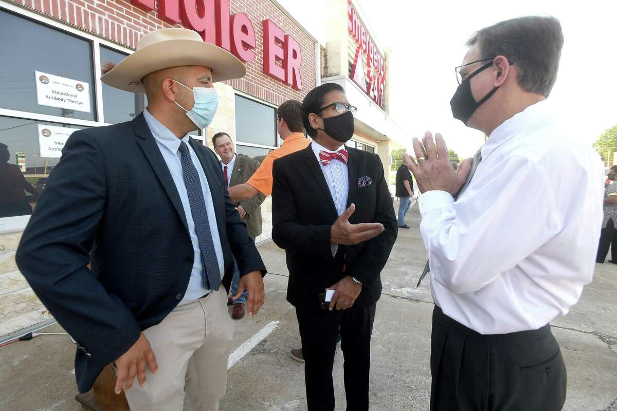 Jefferson County Judge Jeff Branick (right) talks with IEM's Gerardo Castillo (left) and Dr. Rashid Chotani about the new infusion center that opened Monday to treat patients with COVID-19. The new center will be able to treat up to 150 patients daily, significantly increasing the number that can be treated amid a steep rise in cases. The treatment is free to patients 12 and older who are within 10 days of conntracting the virus and are not experiencing severe respiratory problems, Photo made Monday, August 23, 2021 Kim Brent/The Enterprise
