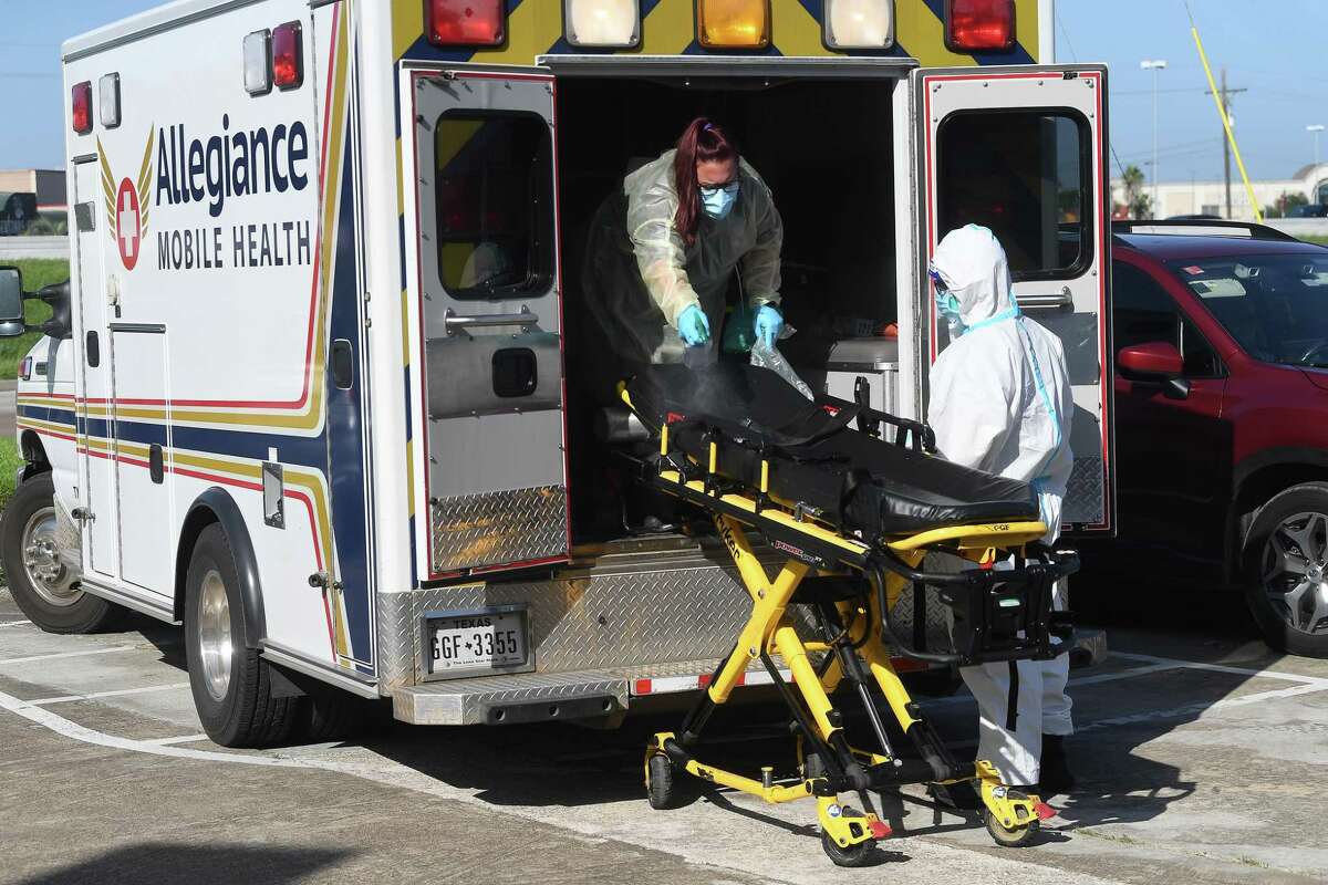 Ambulance workers sanitize their unit and gurney after transporting a patient to the new monoclonal antibody infusion center that opened Monday to help treat patients with COVID-19. The new center will be able to treat up to 150 patients daily, significantly increasing the number that can be treated amid a steep rise in cases. The treatment is free to patients 12 and older who are within 10 days of conntracting the virus and are not experiencing severe respiratory problems, Photo made Monday, August 23, 2021 Kim Brent/The Enterprise