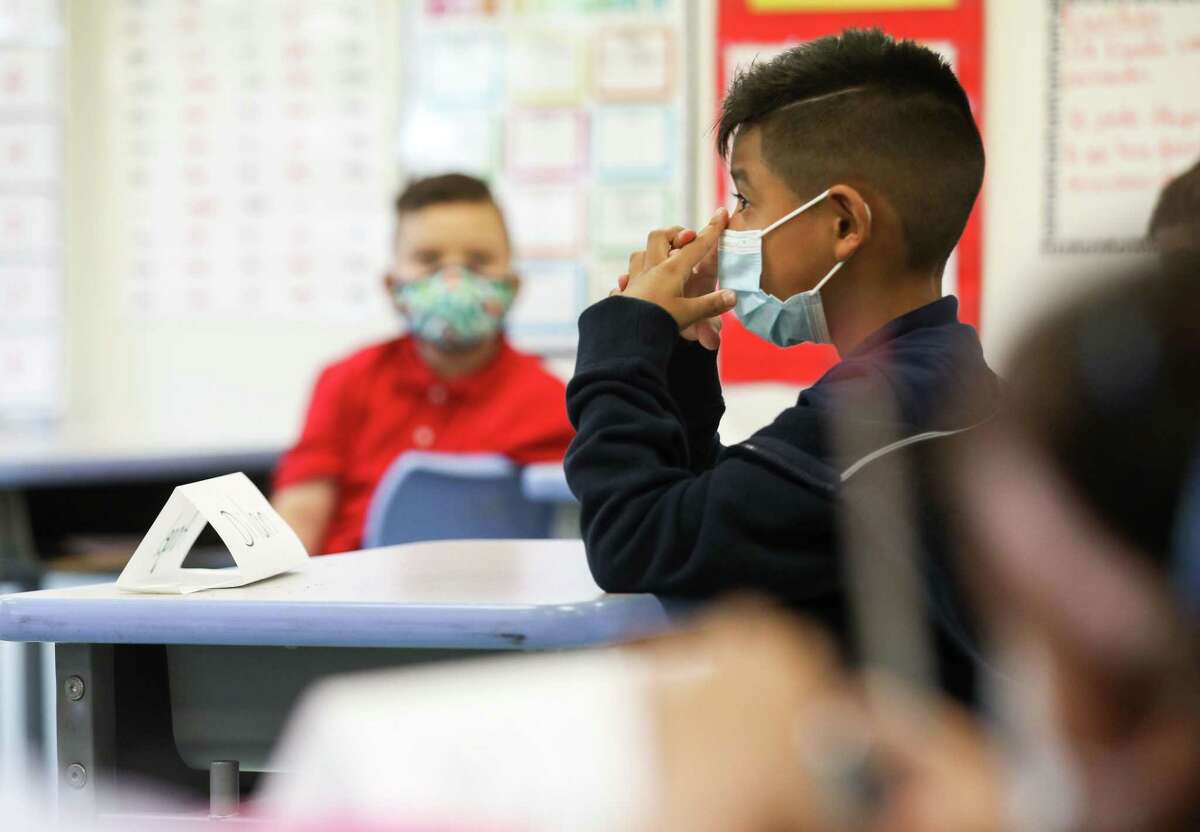A student listens as Claudia Talavera teaches her first-grade class during the first day of classes in Houston Independent School District on Monday, Aug. 23, 2021, at Memorial Elementary School in Houston.