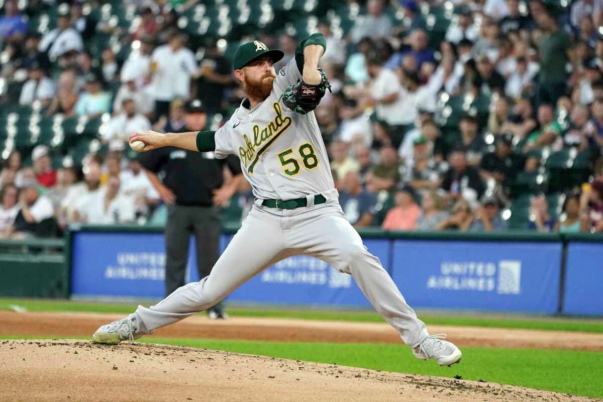 Oakland Athletics starting pitcher Paul Blackburn delivers during the first inning of the team's baseball game against the Chicago White Sox on Wednesday, Aug. 18, 2021, in Chicago. (AP Photo/Charles Rex Arbogast)