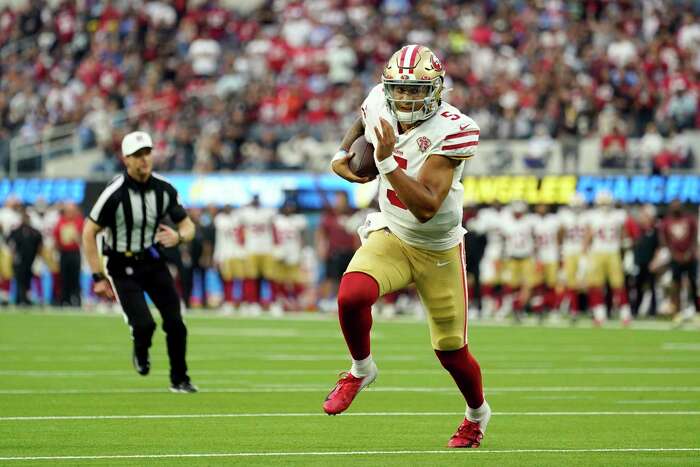 San Francisco 49ers defensive lineman Jordan Willis, right, is hugged by  teammates after sacking Los Angeles Chargers quarterback Easton Stick in  the end zone for safety during the first half of a