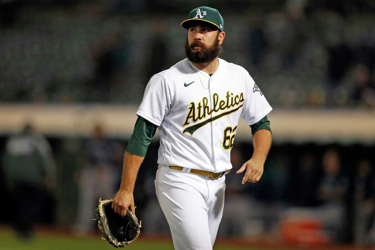 Oakland Athletics' Lou Trivino is removed from game in 9th inning after giving up 3 runs while blowing the save against Seattle Mariners during MLB game at Oakland Coliseum in Oakland, Calif., on Monday, August 23, 2021.