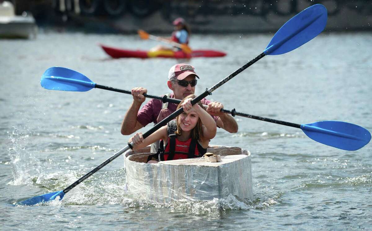 Chelsea Lovece and Tom Lovece paddle to win the Cardboard Kayak Race as SoundWaters hosts the fourth annual HarborFest on Saturday, August 24, 2019, at the Harbor Point Boardwalk in Stamford, Conn.