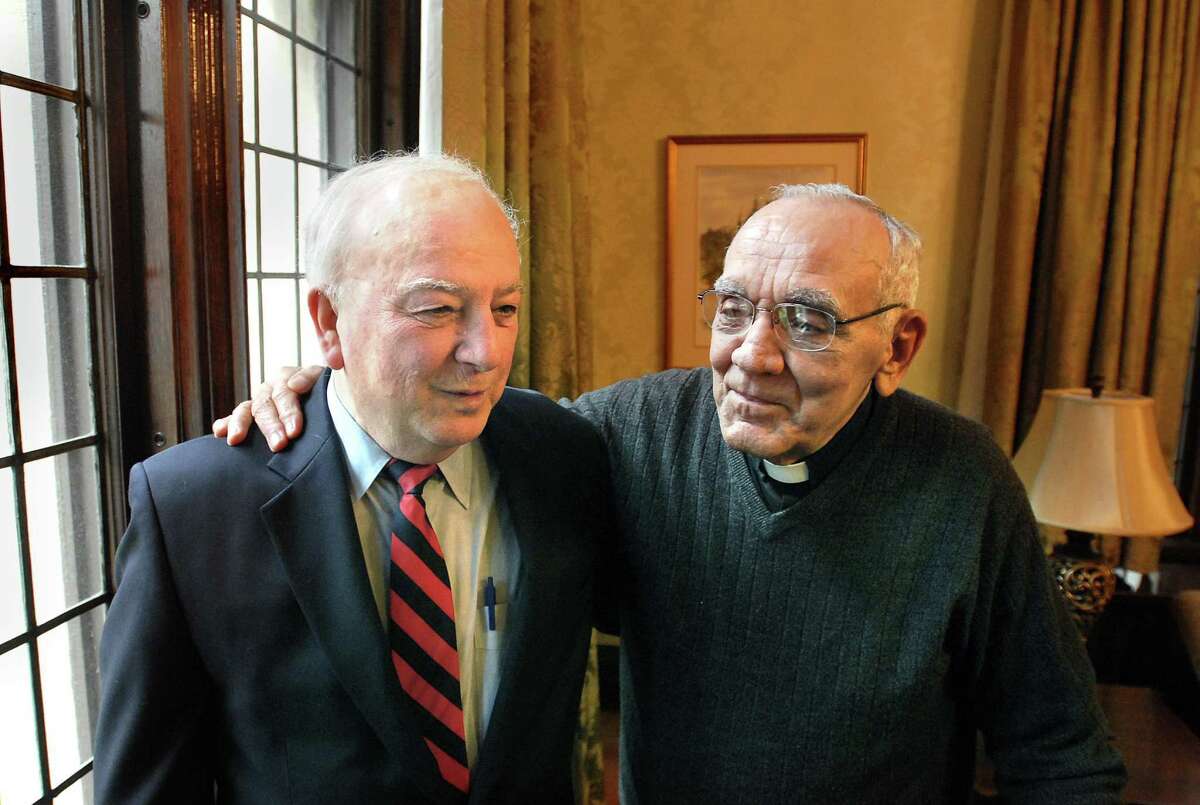 12/12/07 New Haven-- The late Severio "Bob" Fodero, left, and Rev. Albert Caprio share fond Christmas memories together from their time in France while in the service in this file photo.