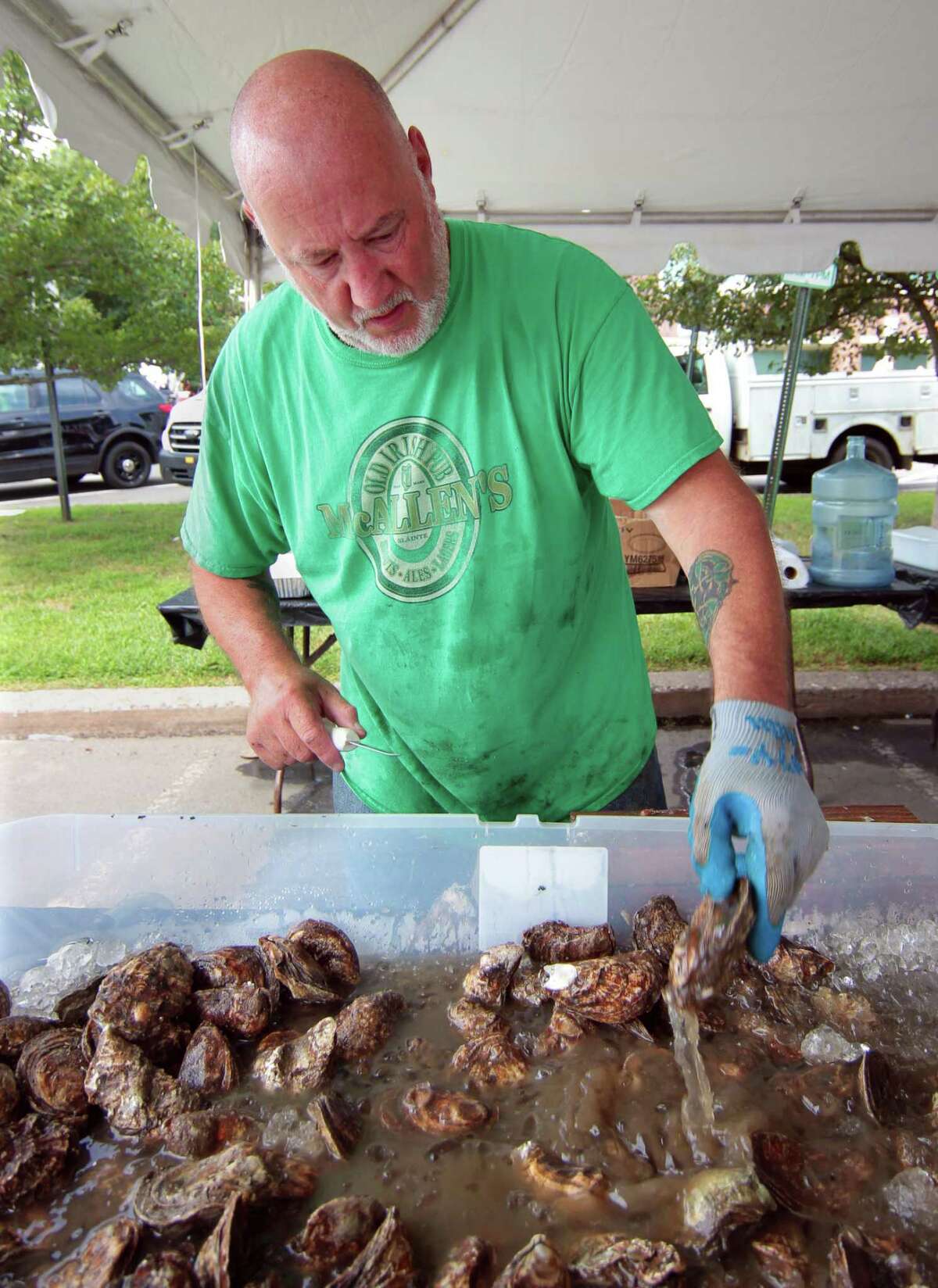 Dave McAllen shucks oysters during the 47th Annual Milford Oyster Festival in downtown Milford, Conn., on Saturday August 21, 2021.