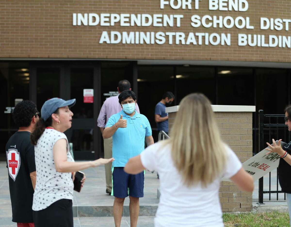 Abhi Gajja, in the blue shirt, tries to explain his position to ask the Fort Bend ISD’s board of trustees to enact a mask mandate for at the Fort Bend ISD Administration building, Wednesday, August 4, 2021, in Sugar Land. The board on Monday voted unanimously Monday to keep masks optional.