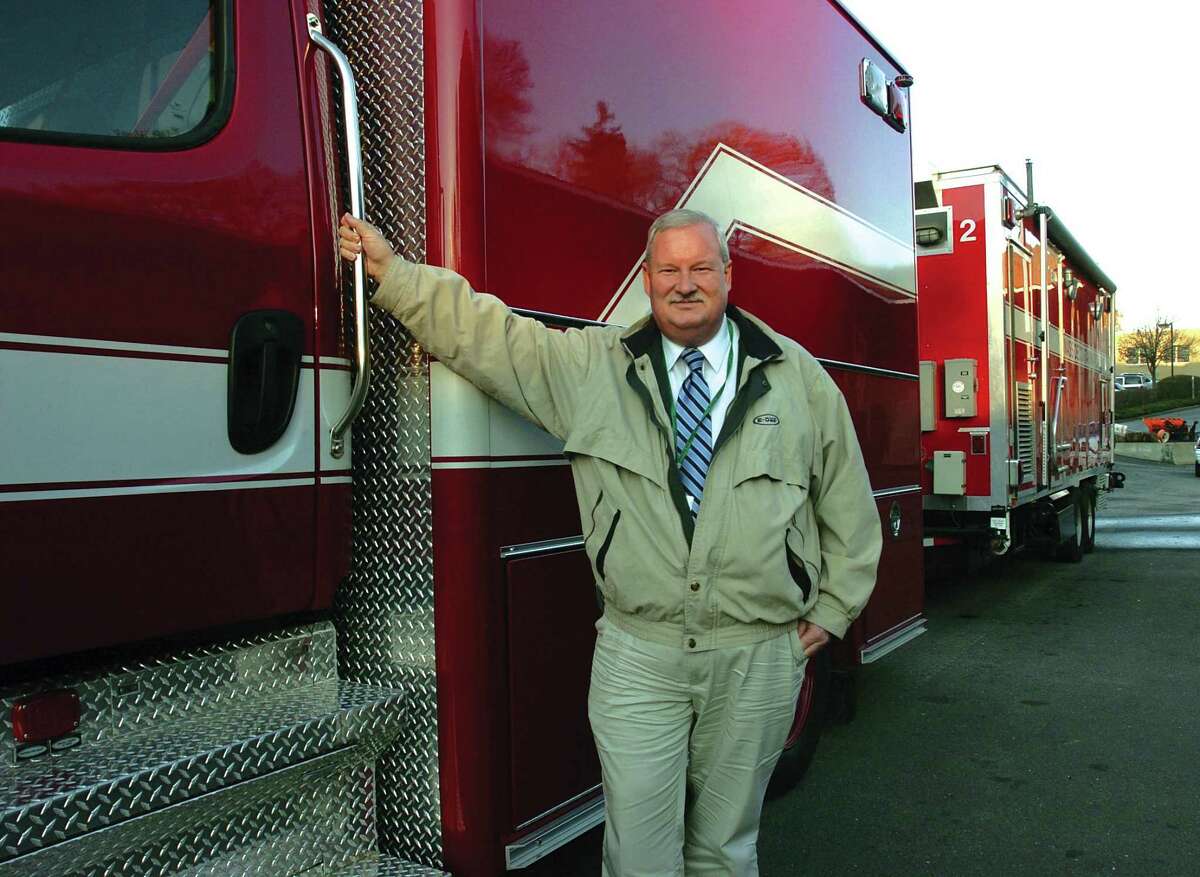 Town Emergency Management Coordinator Dan Warzoha stands at the Fleet Department with the town's new Prime Mover truck, a specially designed vehicle for hauling the town's decontamination trailer and other equipment to respond to a biological attack in Greenwich on Nov. 30, 2005.
