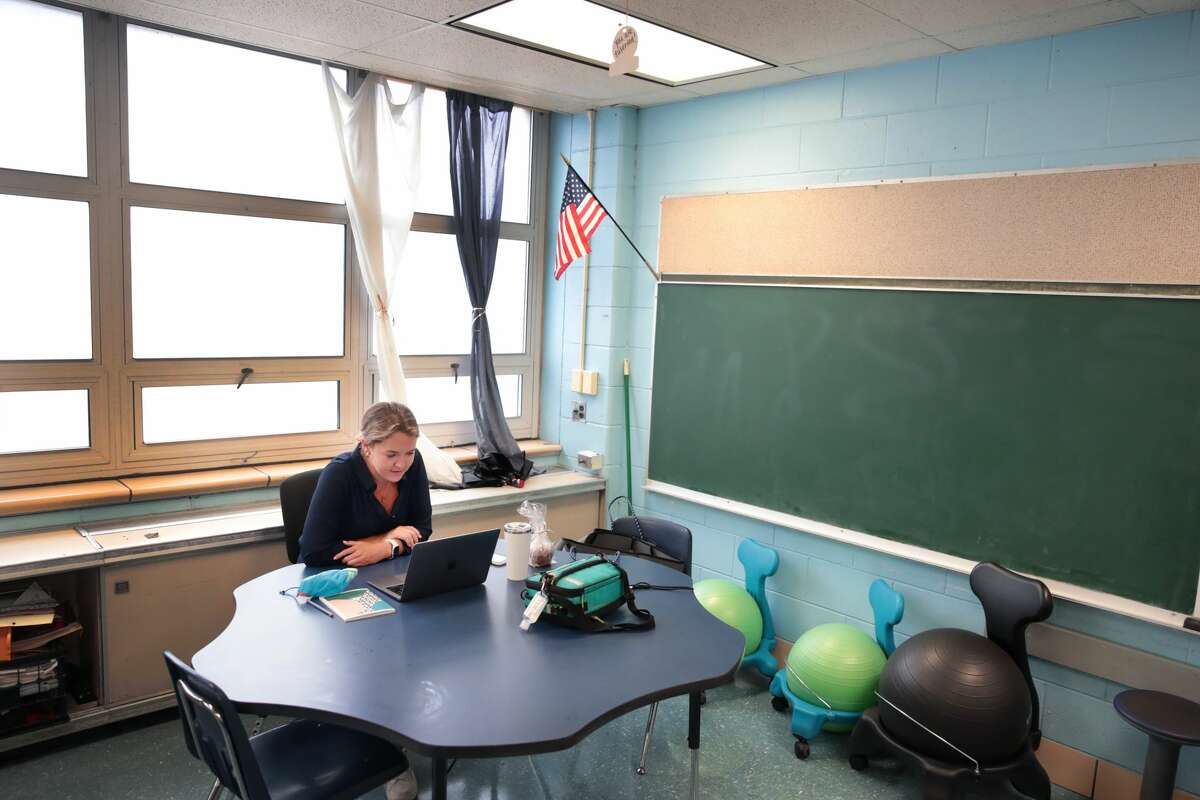 Lucy Baldwin, a teacher at King Elementary School, sits in an empty classroom teaching her students remotely during the first day of classes on September 08, 2020 in Chicago, Illinois. (Photo by Scott Olson/Getty Images)