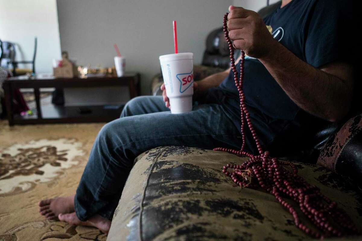 “Khan”, an Afghan Special Immigrant Visa holder, sits with his family as he settles into an apartment they are staying in after fleeing the Taliban in Afghanistan on Monday, Aug. 23, 2021 in Houston. The family arrived in Houston Sunday night.