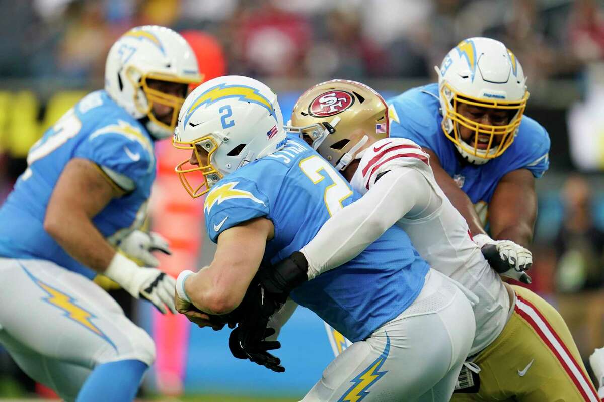 San Francisco 49ers defensive lineman Jordan Willis, right, is hugged by  teammates after sacking Los Angeles Chargers quarterback Easton Stick in  the end zone for safety during the first half of a