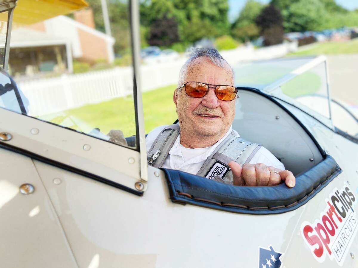 Nestor Gendreau of Higganum is shown in the cockpit of an 81-year-old airplane. Gendreau, 94, flew the aircraft as part of a commemorative event, sponsored locally by Sport Clips and organized by Dream Flights International.