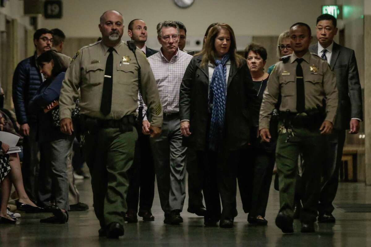 Jim Steinle (checked shirt, left), Kate Steinle’s father and Elizabeth Sullivan (black shirt, back right), Kate Steinle’s mother, make their way through the Hall of Justice on the day of closing arguments in the trial of her accused killer in 2017.