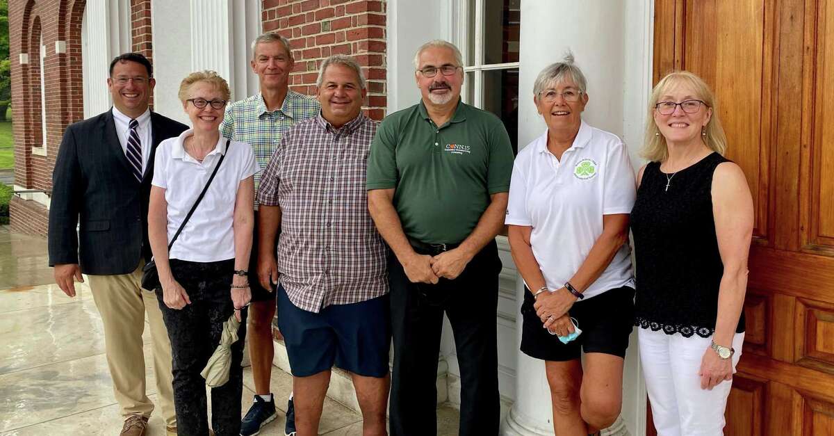 Milford Mayor Ben Blake celebrates the opening of the Milford Sports Hall of Fame with HOF committee members Meg Winfield, Tom Blake, Ted Boynton, Bob Dulin, Peg McGowan and Cindy Shepard Stewart.