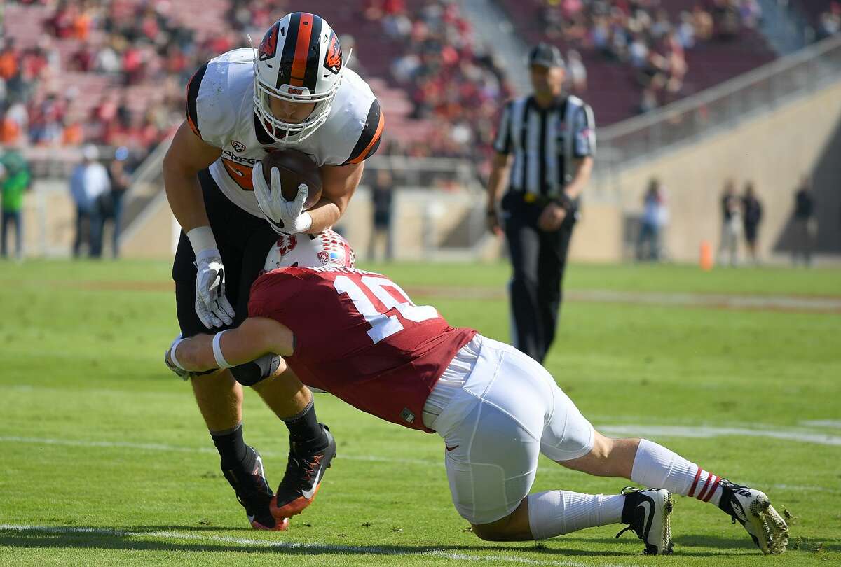Ryan Nall of the Oregon State Beavers gets tackled by Zach Hoffpauir of the Stanford Cardinal during the first quarter of their NCAA football game at Stanford Stadium on November 5, 2016 in Palo Alto, California. 
