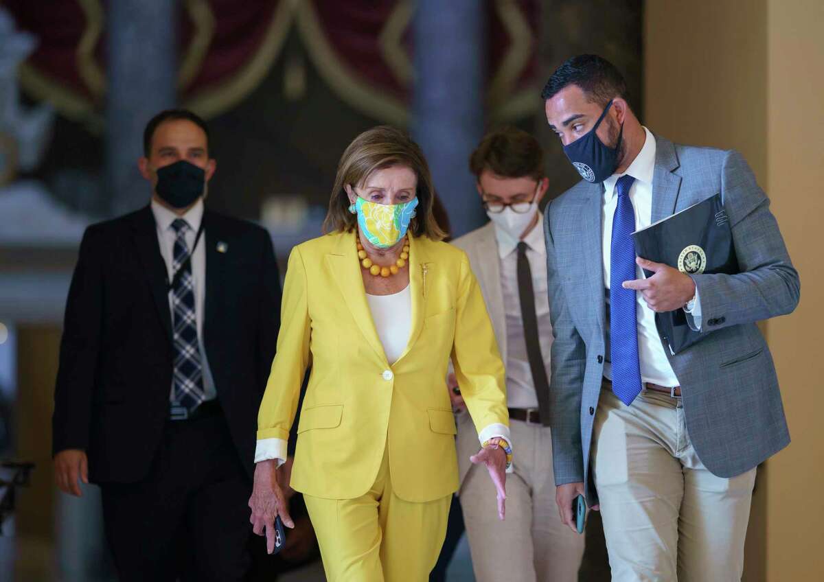Speaker of the House Nancy Pelosi, D-Calif., walks to the chamber Tuesday after urging advancement of the John Lewis Voting Rights Advancement Act, named for the late congressman.