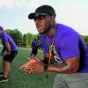 Westhill High School football coach Aland Joseph drills his players during practice at the school in Stamford, Conn., on Tuesday August 24, 2021.