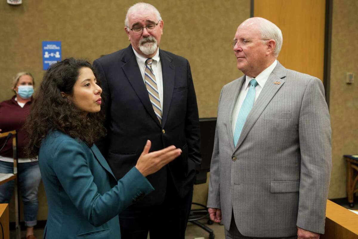 County Judge Lina Hidalgo talks to commissioners Jack Cagle, and Tom Ramsey during a break during Harris County Commissioners Court Tuesday, July 20, 2021 in Houston.