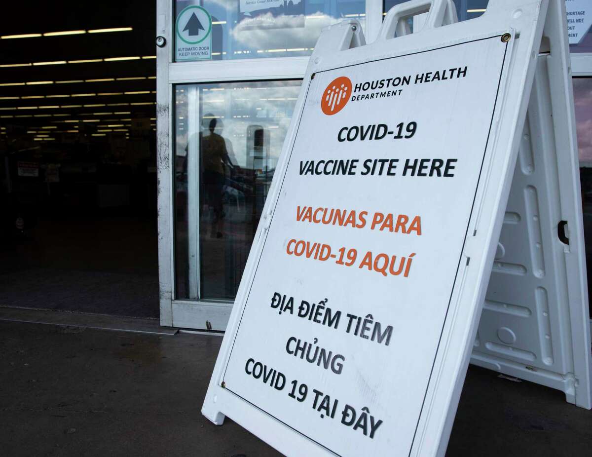 A multi-language Houston Health Department COVID-19 sign is plaed outside at a Food Town vaccine site Tuesday, Aug. 24, 2021, in Houston.