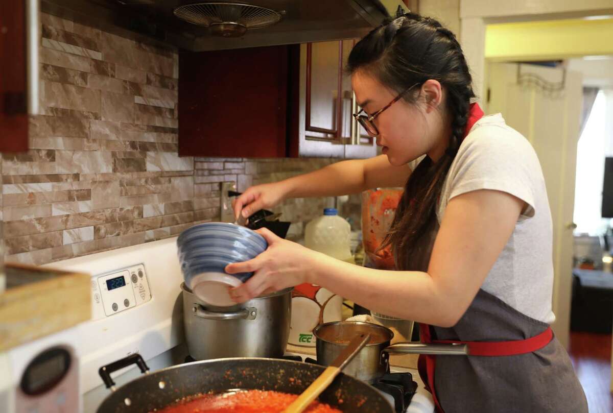 Chef Em Lim of Dabao Singapore cooks noodles in her kitchen in May 2020.