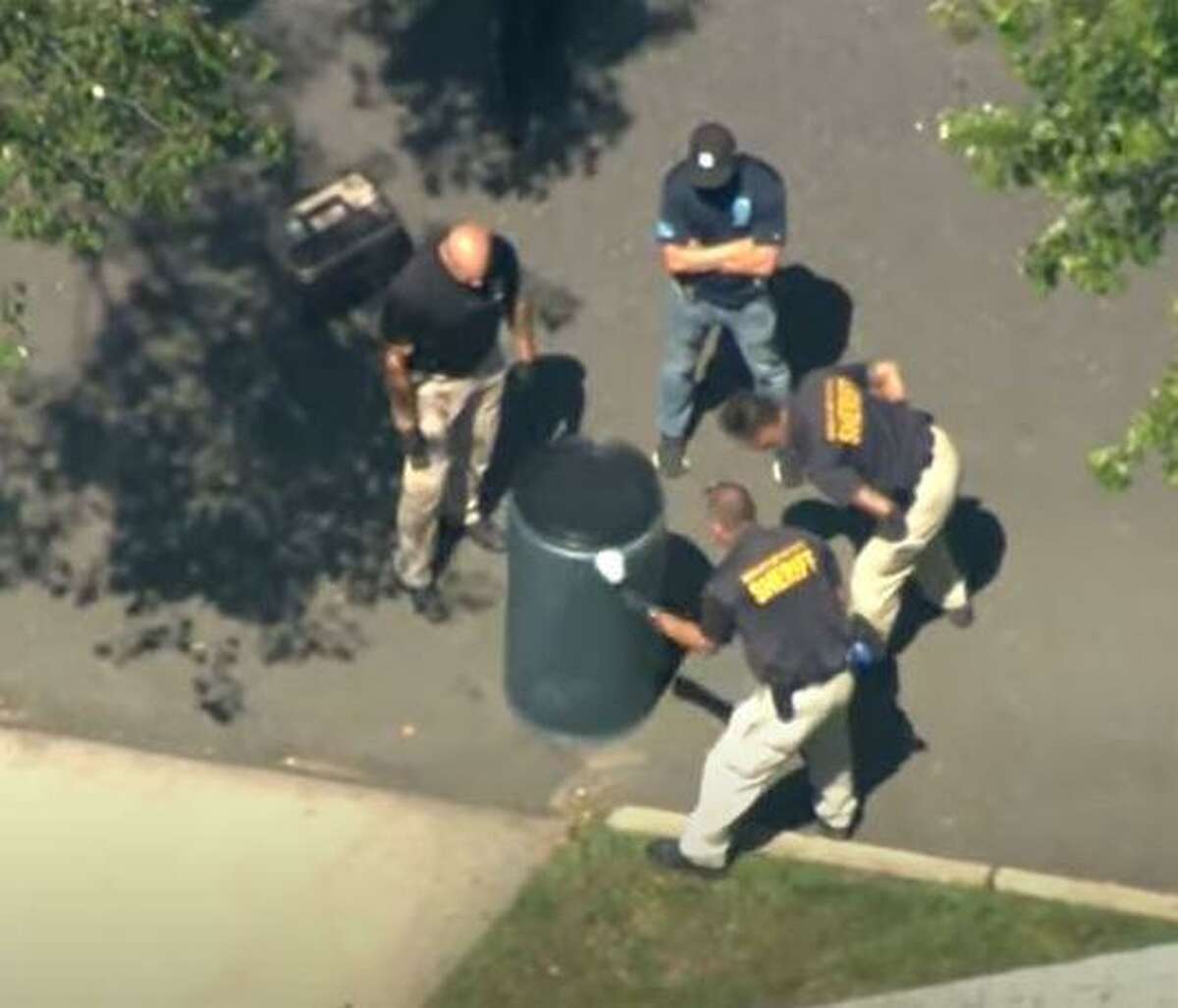 Bergen County investigators dusting a barrel where Flanagan’s body was found inside.