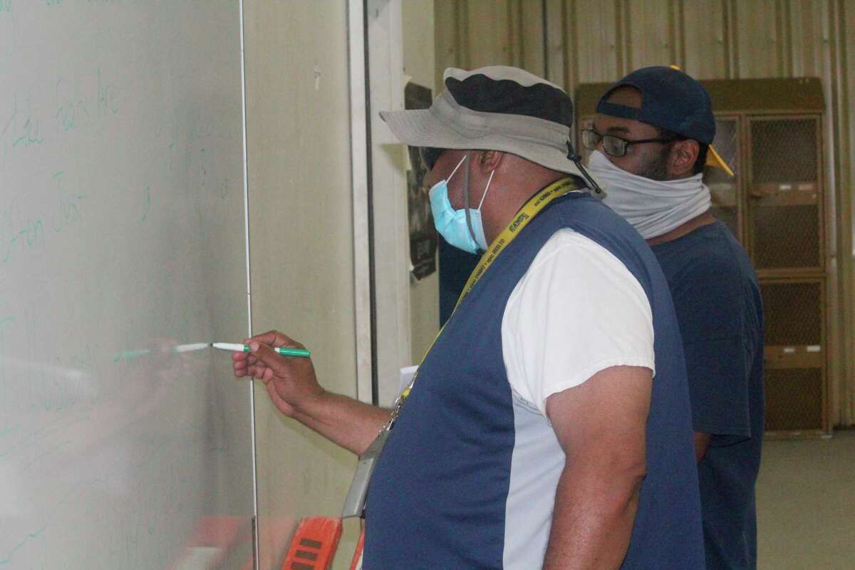Baldwin football coach Bob Watkins draws up a play during a football practice last season. (Star file photo)