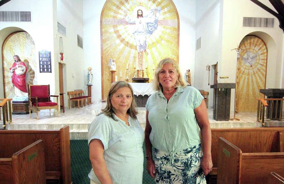 Antonia Damico, President of the La Madonna di Canneto Society, and former parishioner Phyllis T. Cecio, right, pose at Sacred Heart Church in Stamford, Conn., on Wednesday August 25, 2021. Damico, Cecio and several other society members as well as parishioners are searching for a missing painting at the church. The painting, which is used once a year for a special mass held by descendants from a small village in Italy, was being stored at the church, and was last seen in May.