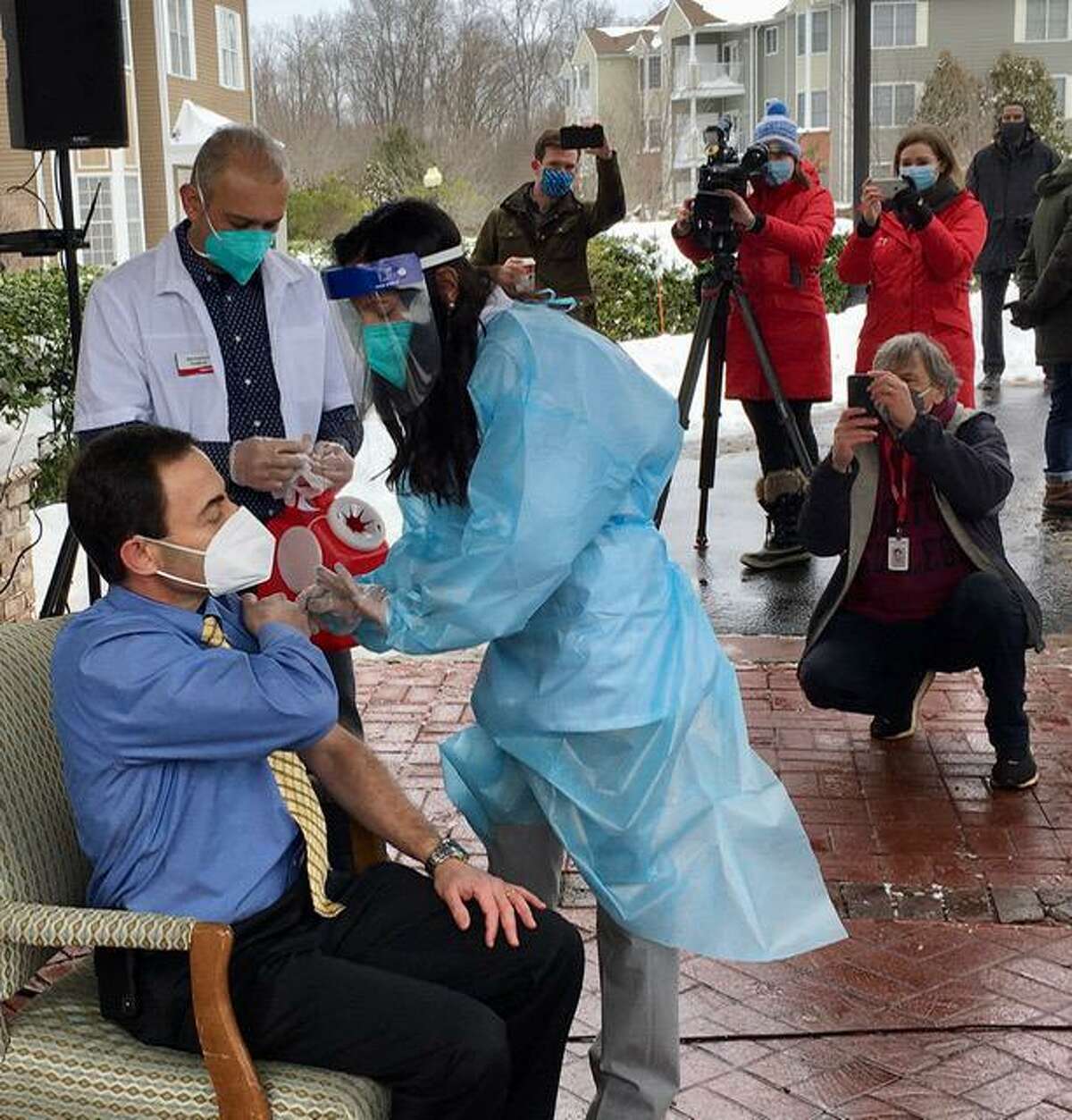 Dr. Richard Feifer gets vaccinated outside The Reservoir nursing home in West Hartford.