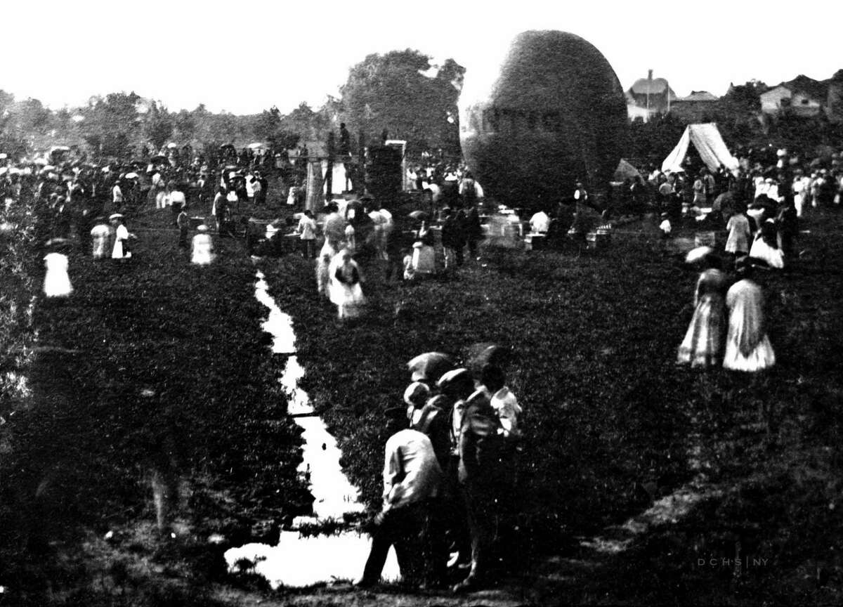 Nellie Thurston and Herman Squire each took off from Eastman Park in Poughkeepsie on July 4, 1871. In this historic photo of the day, crowds are gathered to watch the feat. Squire’s balloon “Atlantic” can be seen in the background.