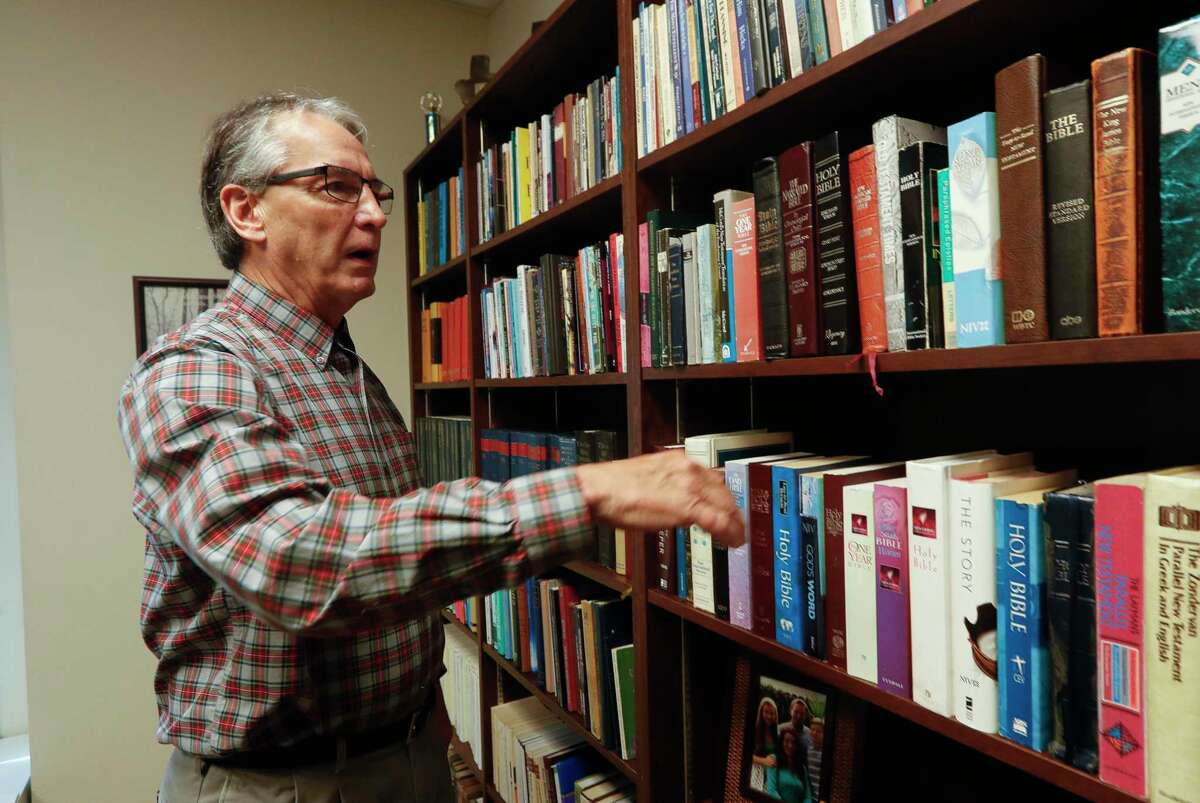 Pastor Steve Yates, who recently stepped down as Senior Minister with Conroe Church of Christ, goes through his extensive library, Tuesday, Aug. 24, 2021, in Conroe. Yates, now Spiritual Growth Minister, stepped down from leading the congregation after 36 years.