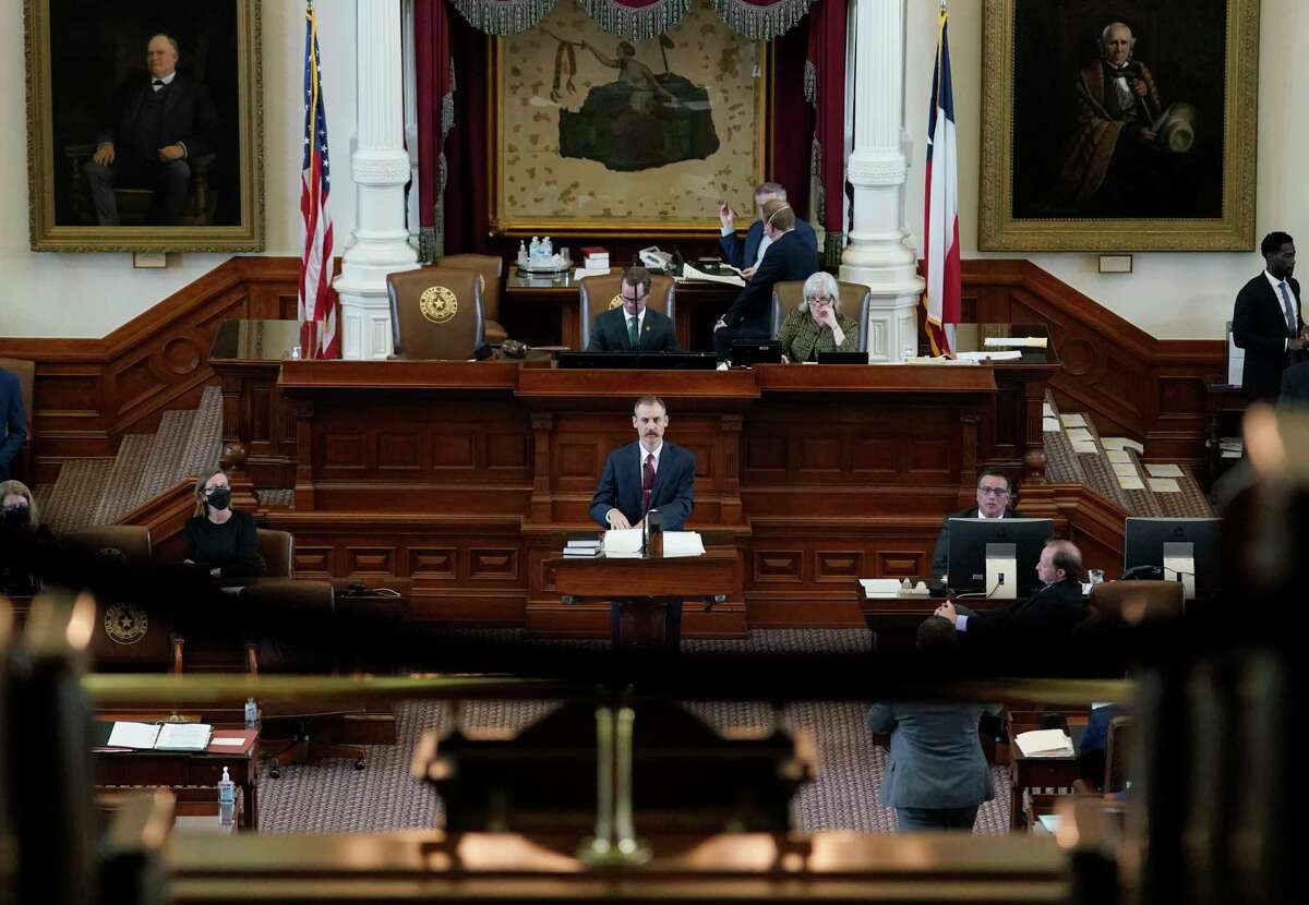 Texas State Rep. Andrew Murr, R-Kerrville, center, answers questions of fellow lawmakers as they debate voting bill SB1 in the House Chamber at the Texas Capitol, Thursday, Aug. 26, 2021, in Austin, Texas.