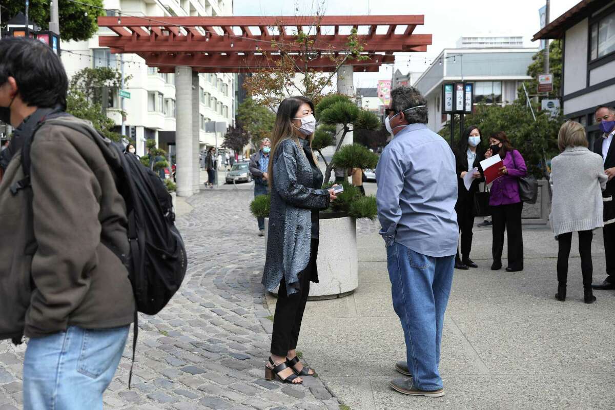 Linda Mihara, retail director of the Paper Tree, visits with Paul Lanier, son of sculptor Ruth Asawa, in Japantown after a news conference announcing $5 million in state funding for the repair and upgrade of Buchanan Mall.